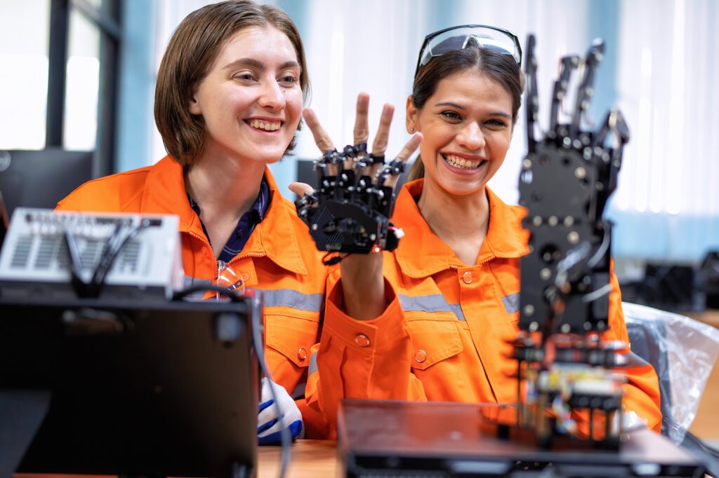 Girl engineer in robot industry fabrication research room simulate testing robot arm on operation