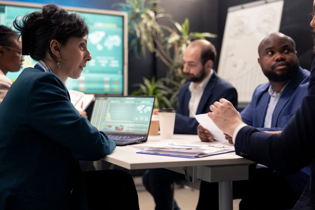 Team of business associates debating ways to increase profit